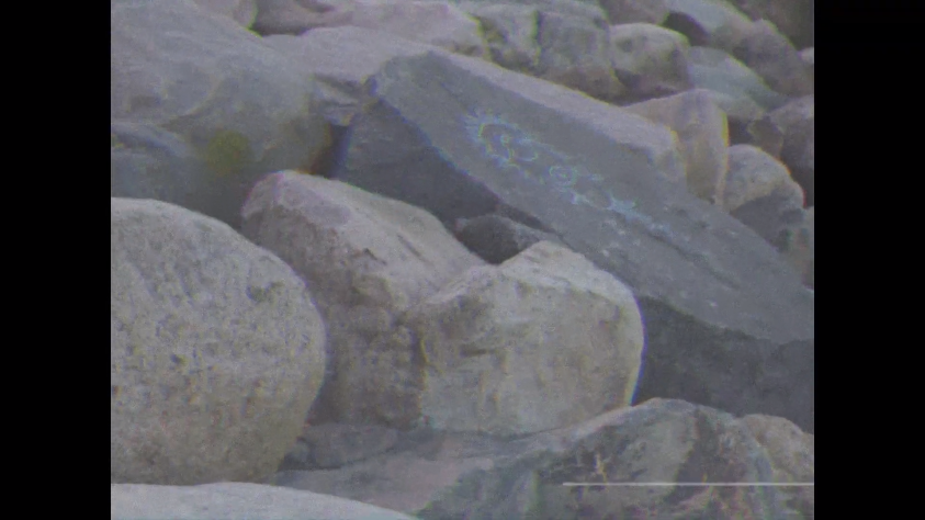 Камень с символами из видео.