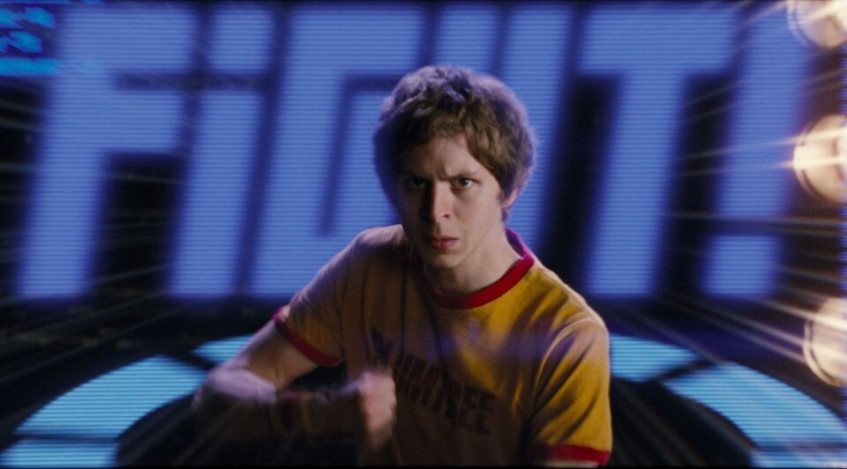 Скотт Пилигрим с кризисом среднего возраста, но всё ещё лицом подростка.Майкл Сера